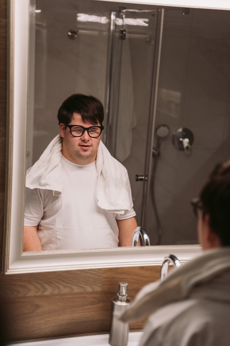 A Man Looking At A Mirror 