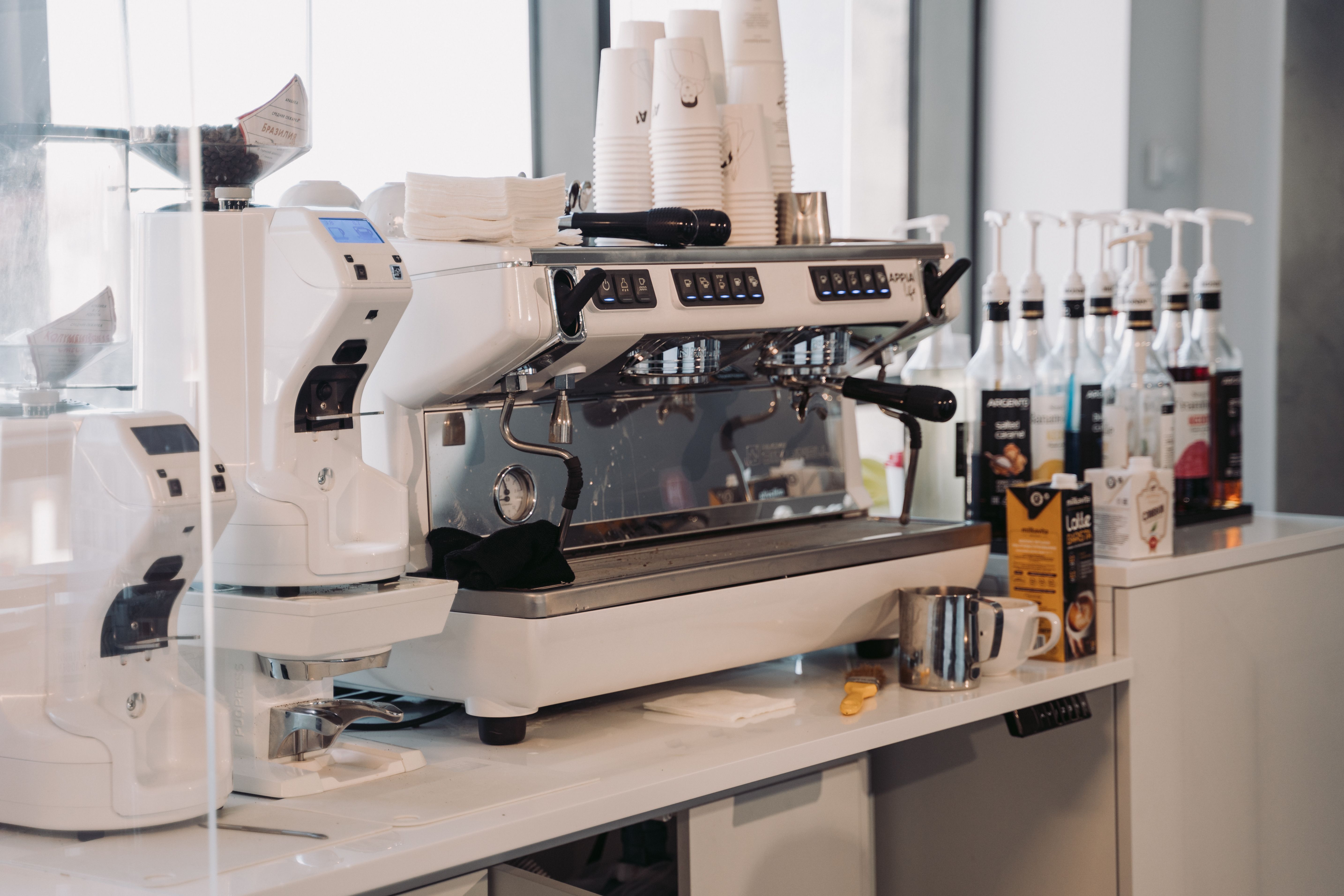 Espresso machine with accessories in a modern café setting, perfect for coffee enthusiasts.