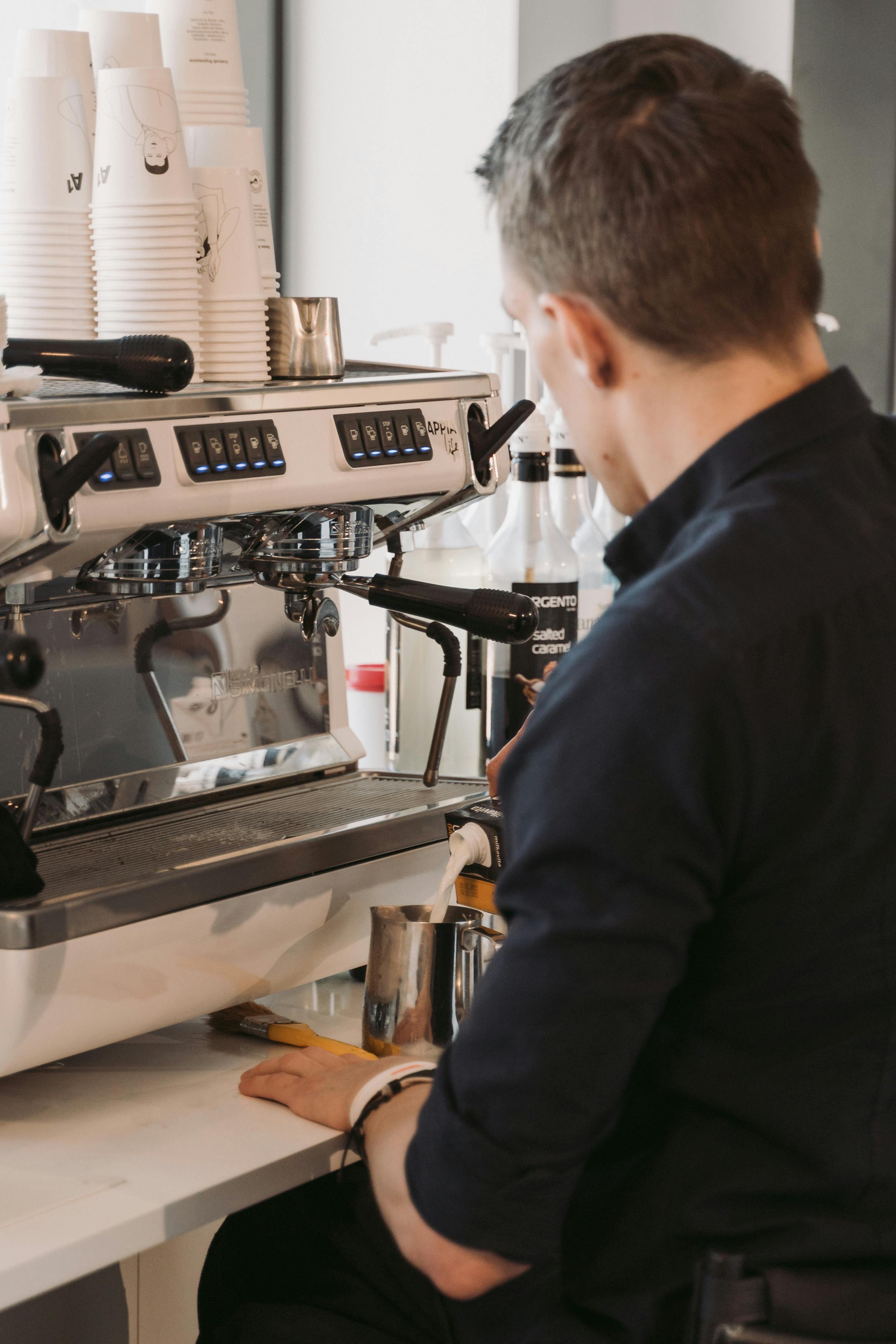 Person using a hand press espresso maker stock photo - OFFSET