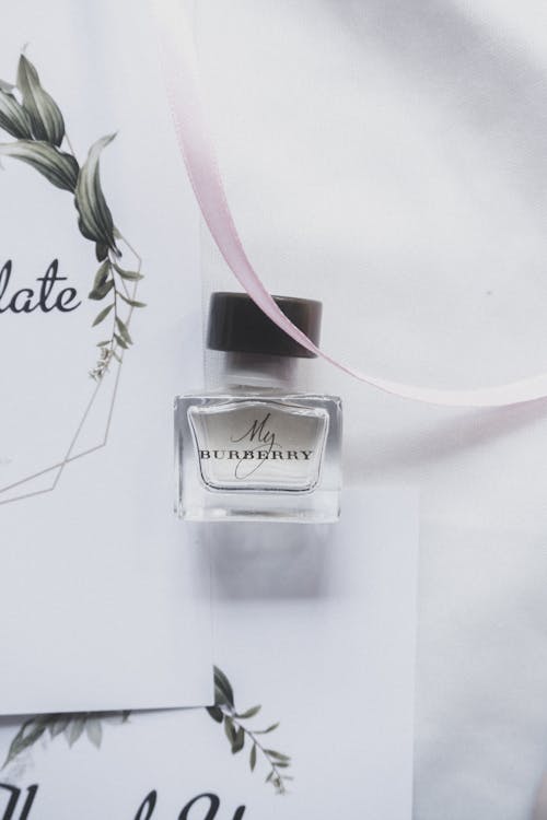 Free Perfume Bottle on White Paper Stock Photo