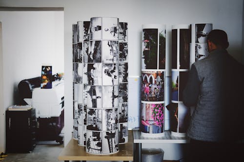 Man Standing in Front of Photo Stands