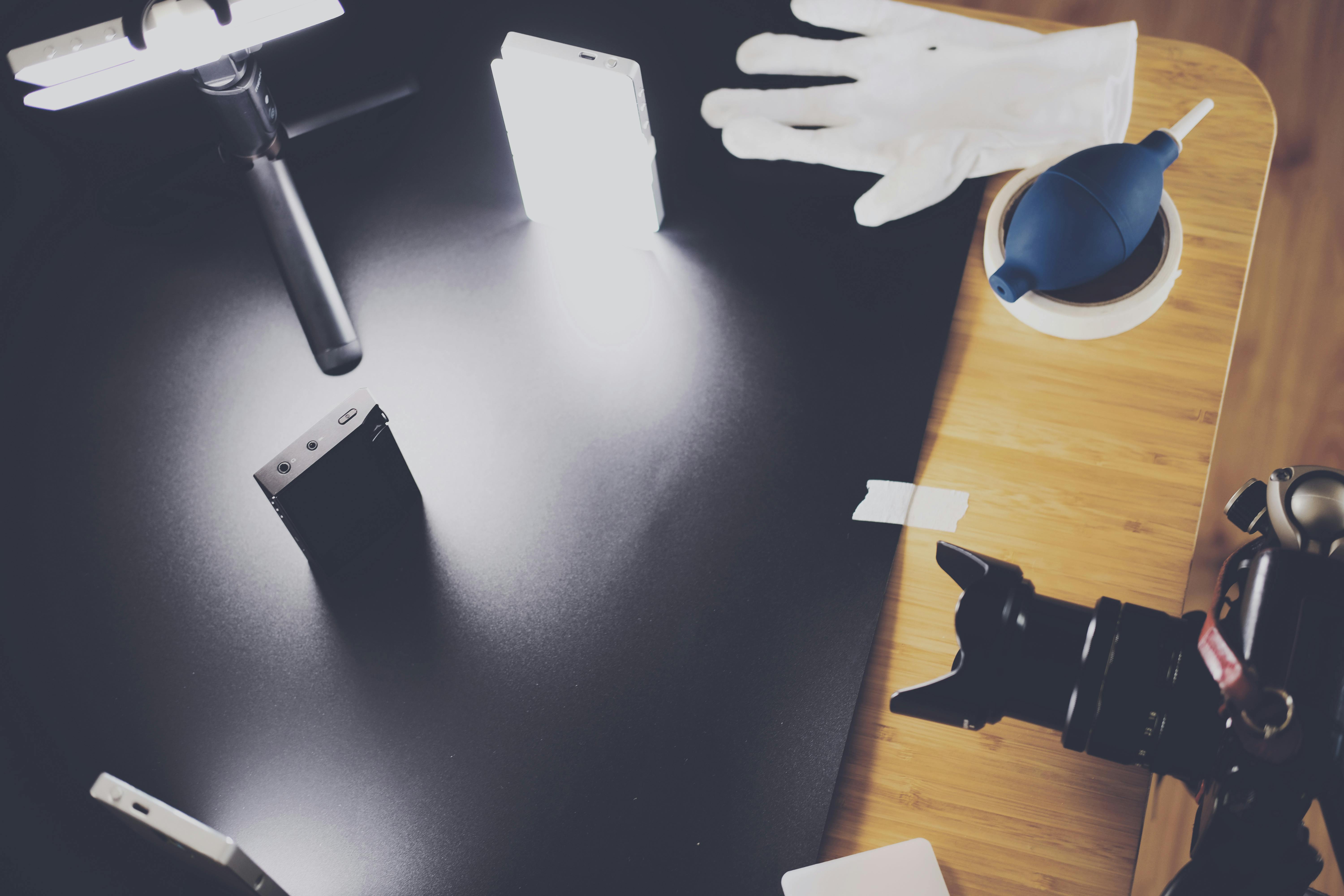 black dslr camera on top of brown wooden table