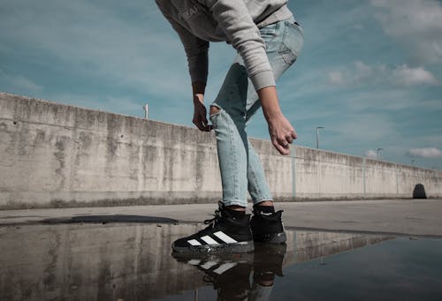 Person in Casual Wear Standing on a Puddle