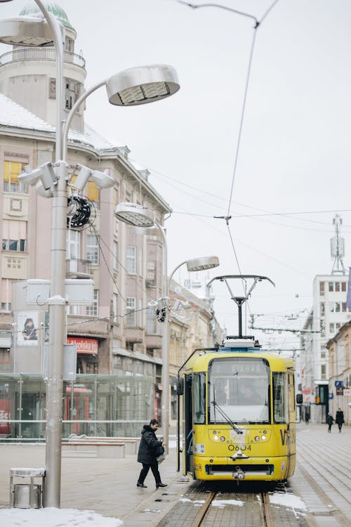 Yellow and White Tram on Road