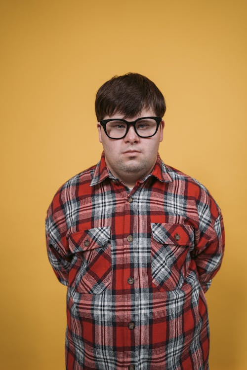 Man in Red White and Black Plaid Shirt Wearing Black Framed Eyeglasses