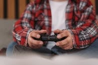 Person Holding Black Game Controller