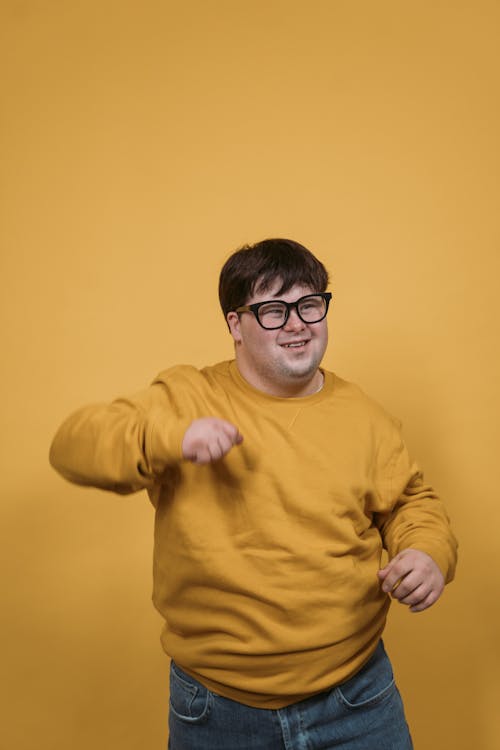 Happy Man in Yellow Pullover Dancing