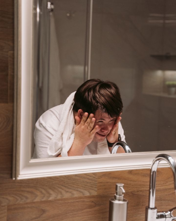 Adult man with Down syndrome completing his morning self-care routine