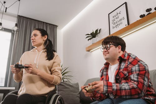 A Man and Woman Holding Game Controllers