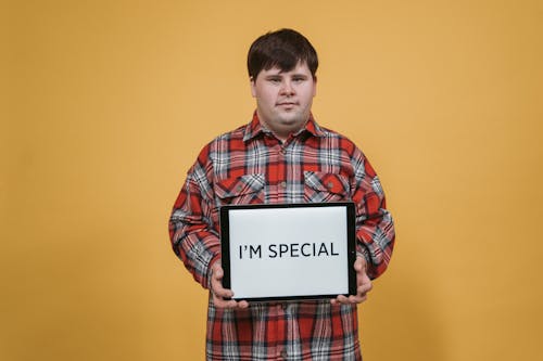 Man in Plaid Shirt Holding a Digital Tablet