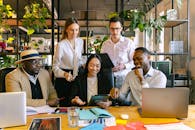 A group of diverse professionals working collaboratively in a modern office setting.
