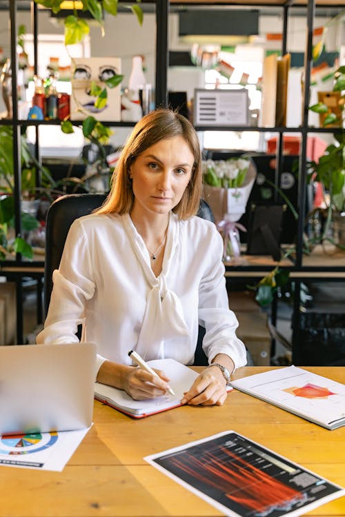 Portrait Shot of an Employee Writing Some Notes