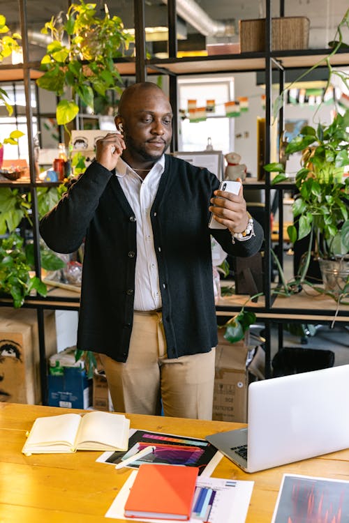 Free Man Talking on Smartphone in Office Stock Photo