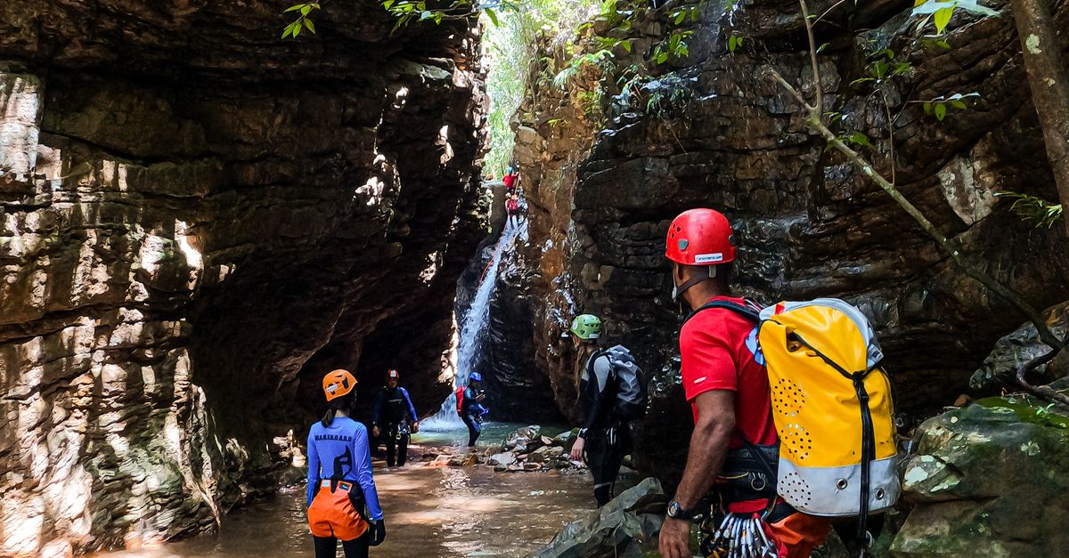 Walk Besides Stream People Walking Across Stream in Mountains · Free Stock Photo