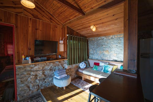 TV in rustic styled room with couch