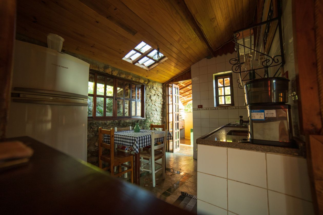 Rustic kitchen with wooden ceiling Rustic kitchen interior with a warm wooden ceiling and vintage furniture