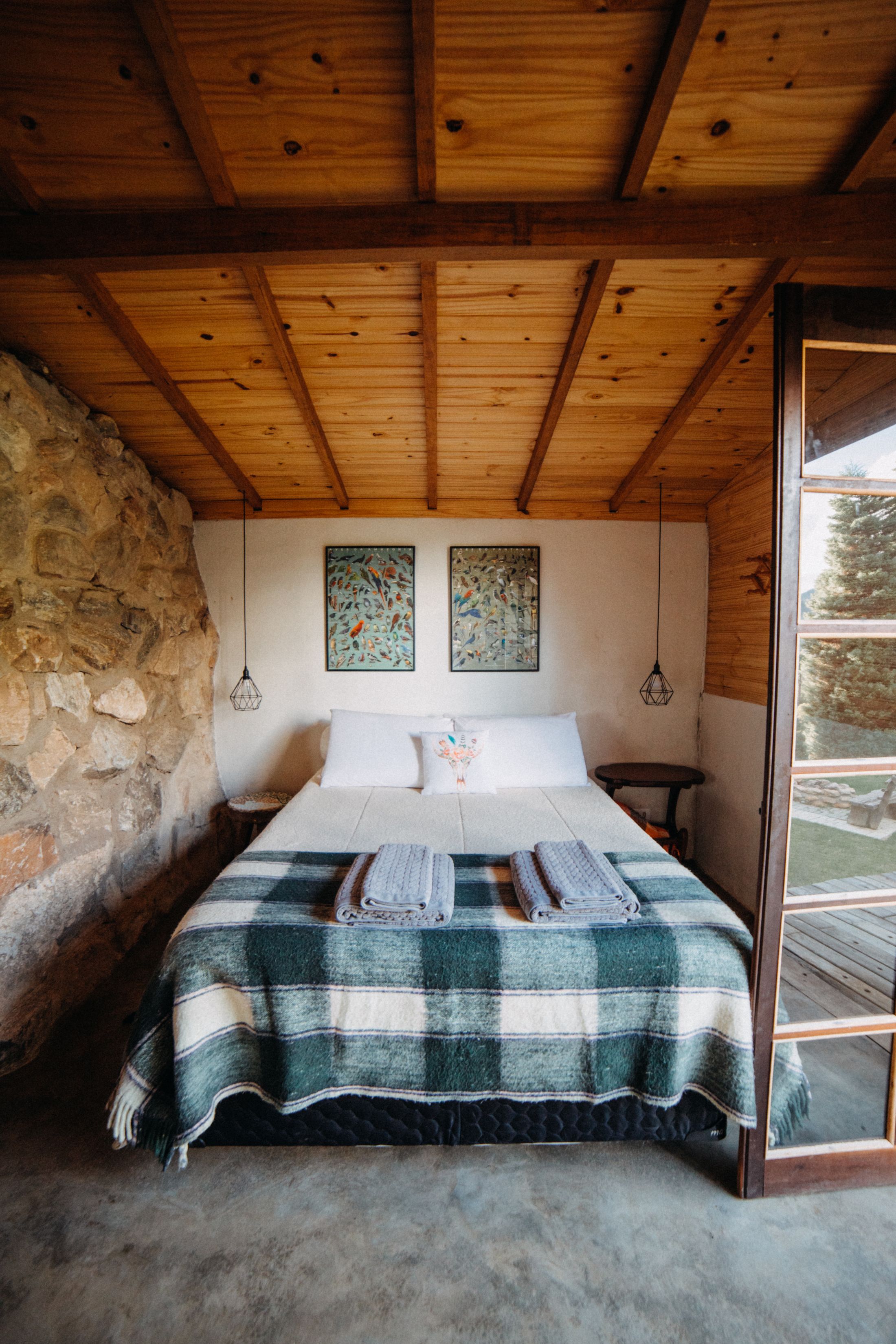 Bedroom with a natural stone wall and modern furnishings