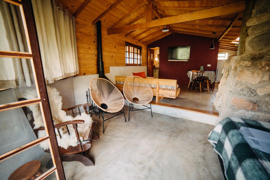 Open-plan cottage living room with a wood stove, photo by Matheus Bertelli on Pexels