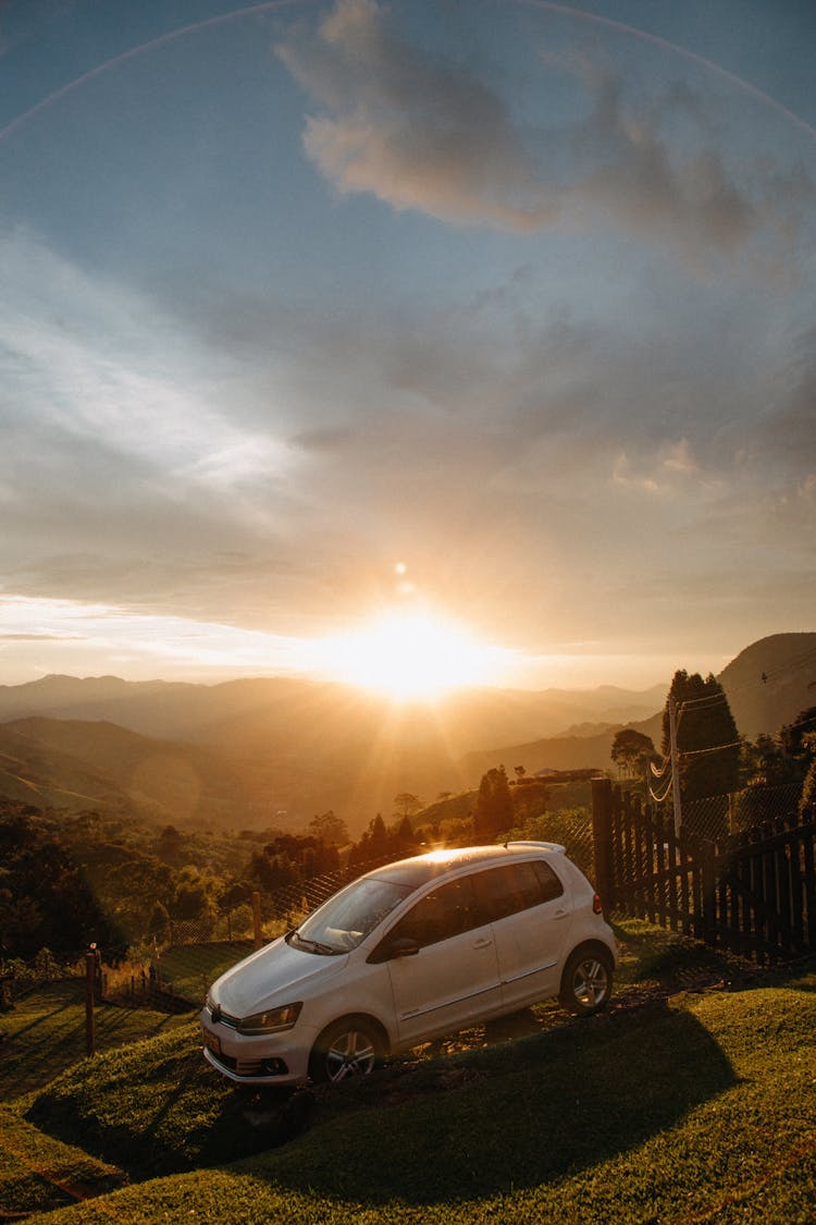 Car Parked In Front Of A Gate To A House In Mountains 