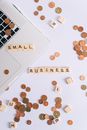 Small Business Scrabble Tiles on Laptop and Table Top with Coins