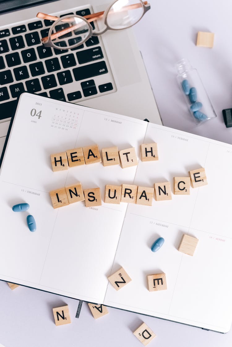 Health Insurance Scrabble Tiles On Planner 