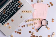Small Business Crash Scrabble Tiles on Laptop and Table Top with Coins