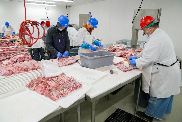 Butchers Slicing Meat 