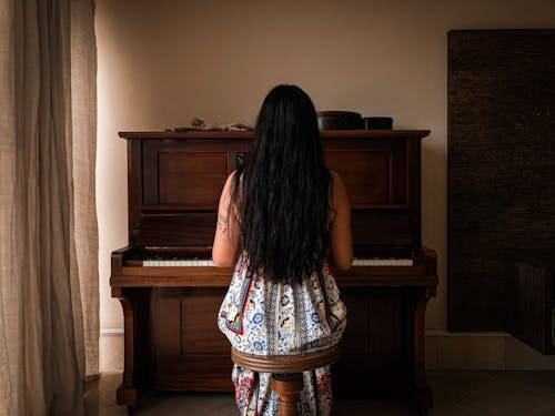Back View of a Woman Playing Piano