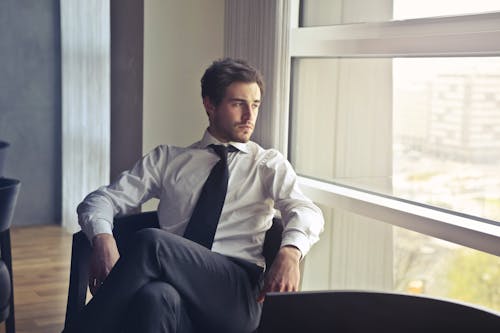 Man Wearing White Dress Shirt and Black Necktie