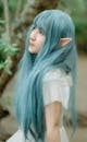 Asian cosplayer in elf costume in forest