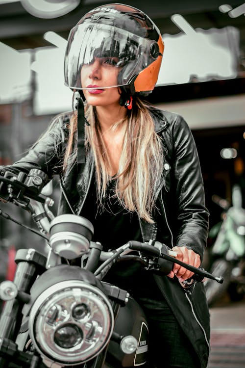 Free Woman in Black Leather Jacket Riding a Black Motorcycle Stock Photo