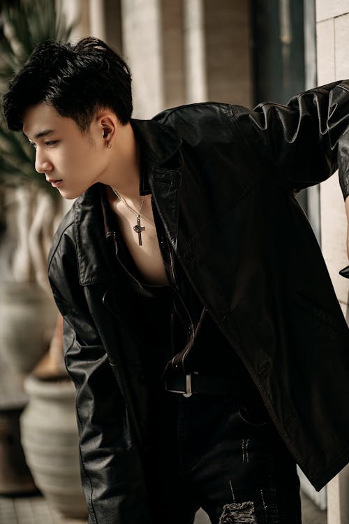 An Asian Man In A Black Denim Jacket And A Chain Necklace Posing