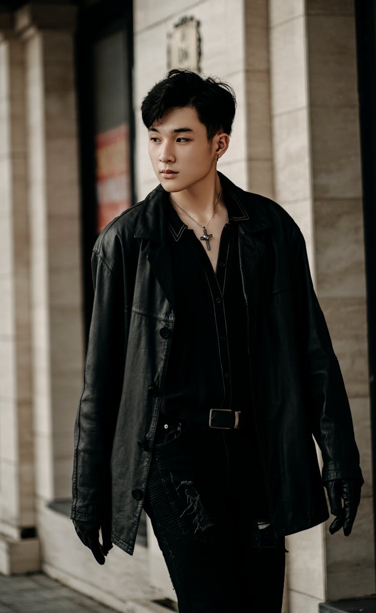 Stylish Asian Man In Black Outfit Walking On Street