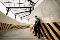 Confident trendy Asian man standing in roofed passage
