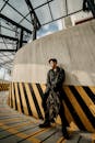 Stylish Asian man standing in roofed parking passage