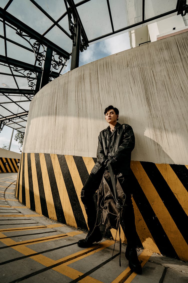 Cool Asian Man Standing In Roofed Parking Passage