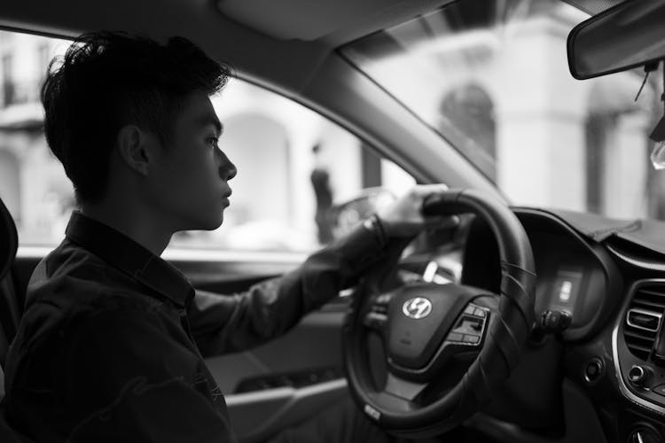 Unemotional Ethnic Man Driving Modern Car