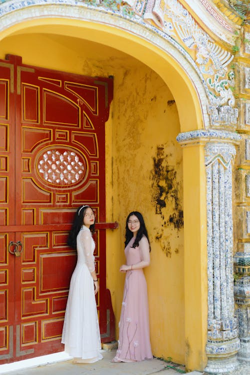 Free Women in White and Pink Dress Standing on the Doorway Stock Photo