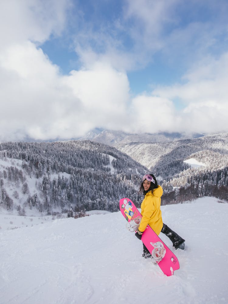 Woman In Winter Clothing Walking On A Snowy Downhill