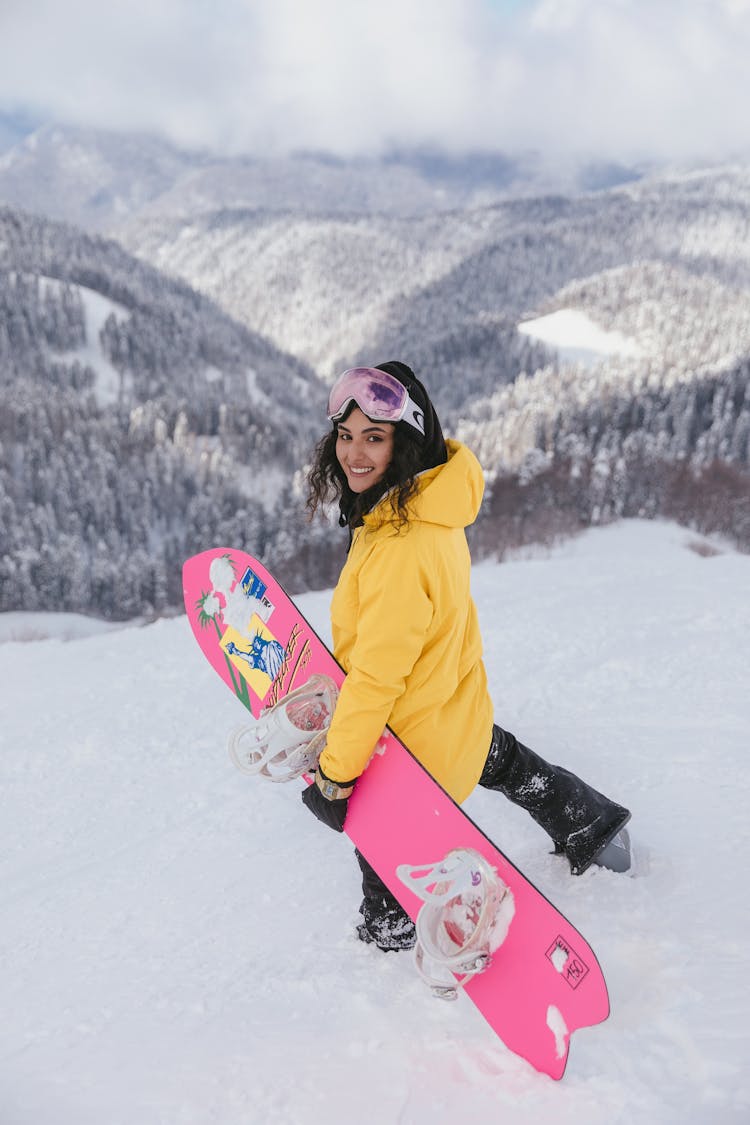 Woman In Winter Clothing Walking On A Snowy Downhill