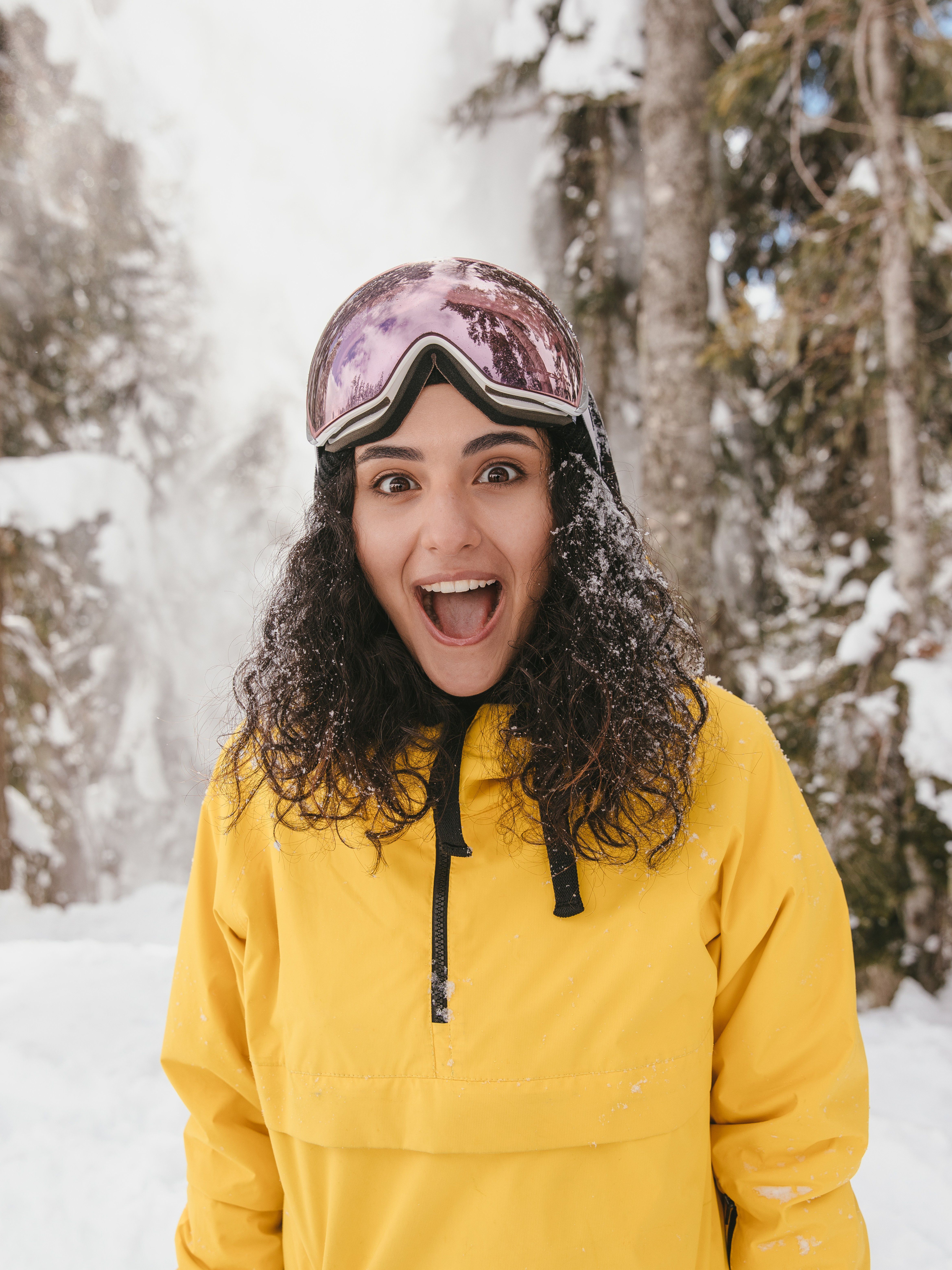 Woman in Yellow Jacket Smiling at the Camera · Free Stock Photo