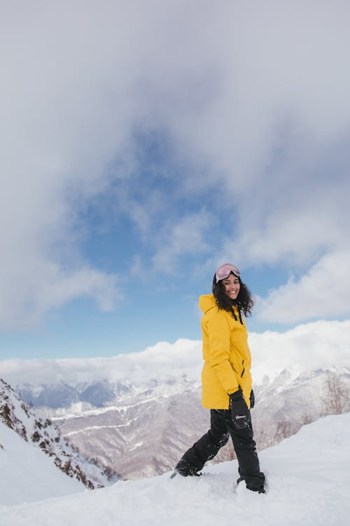 A Woman in Ski Wear on Snowy Mountain