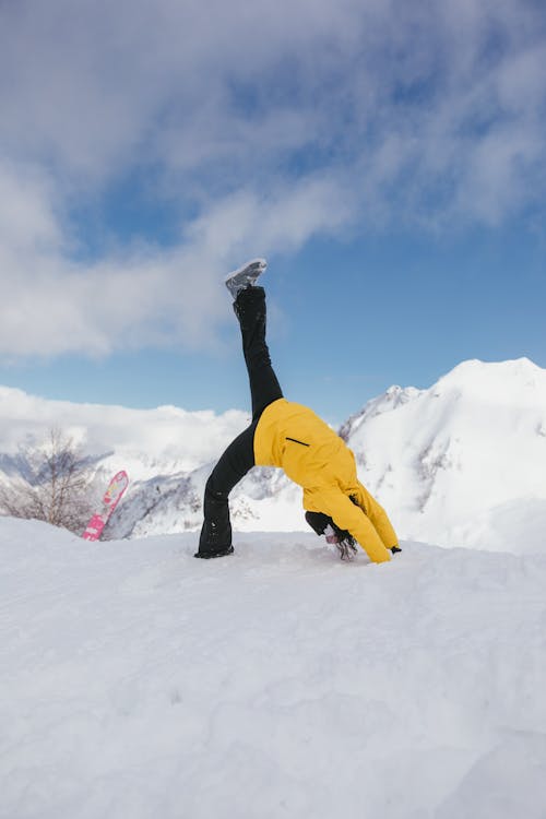 Woman Doing Backflip on Snow