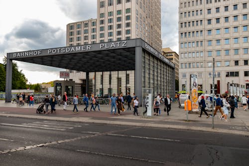 People Walking on Sidewalk Near Building