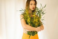 Woman Hugging a Bunch of Flowers for a Photoshoot