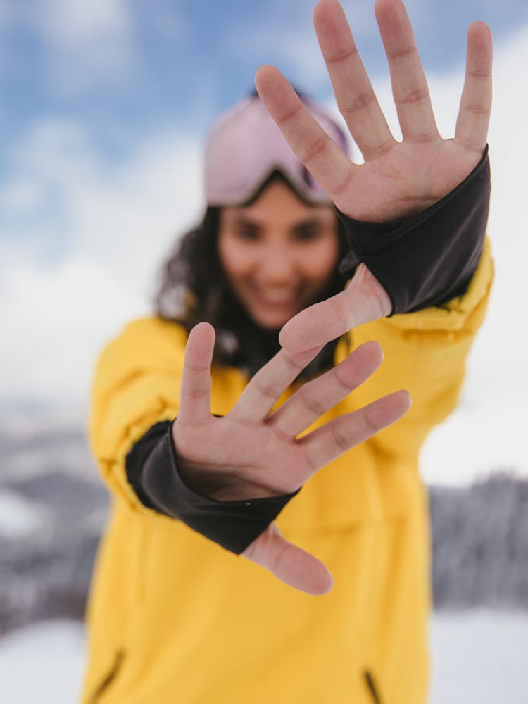 A Woman In Yellow Jacket Showing Her Hands