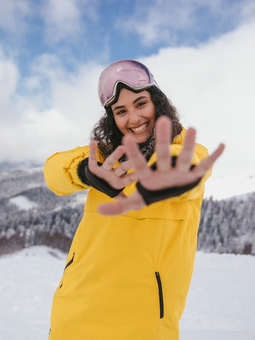A Smiling Woman in Yellow Jacket Wearing a Goggles on Her Head