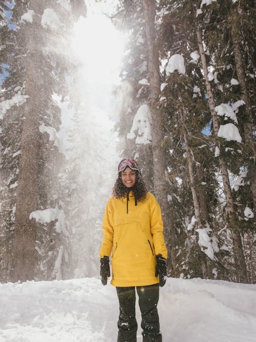 Woman in a Yellow Jacket Enjoying the Snow