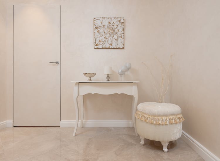 Light Hallway With Beige Table And Soft Stool