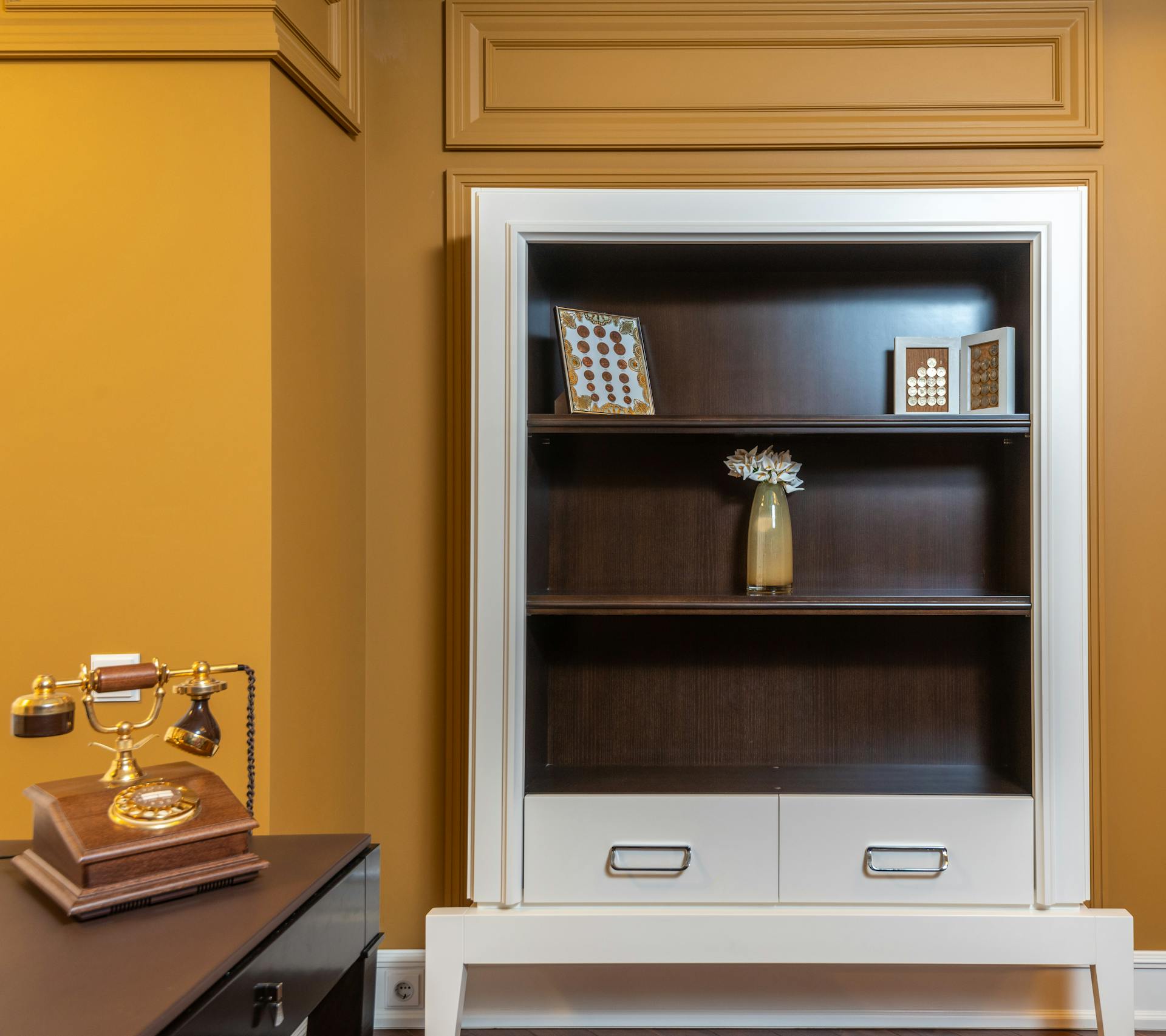 Elegant vintage interior featuring a wooden cabinet and antique telephone